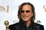 Golden Globes: The Wrestler's Mickey Rourke poses with his award for best performance by an actor in a drama.