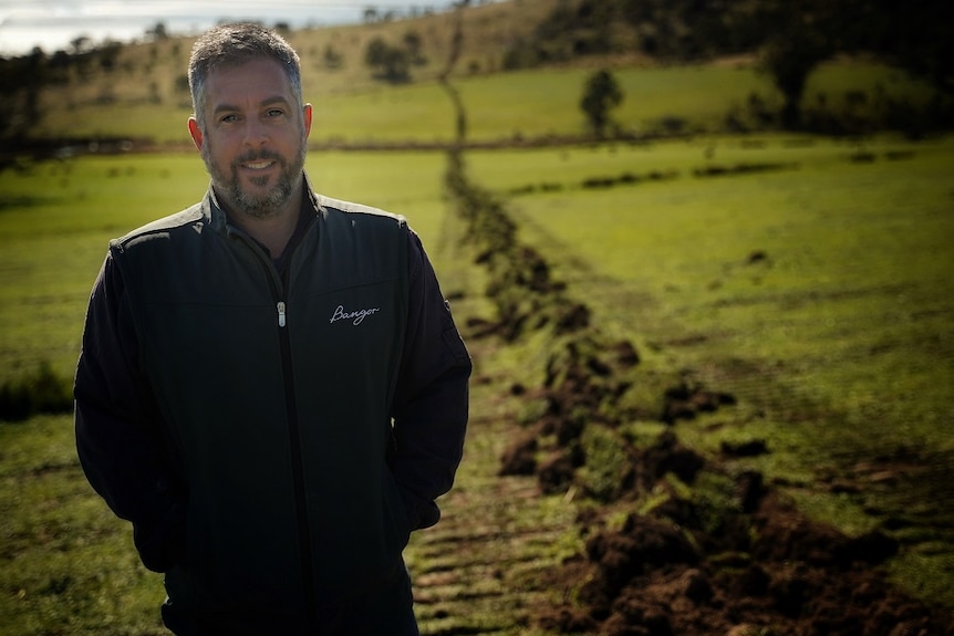 Farmer and vigneron Matt Dunbabin standing next to the construction of his new pipeline.