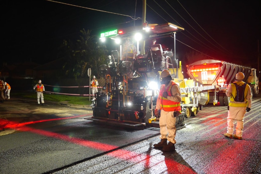 A road being resealed at night.