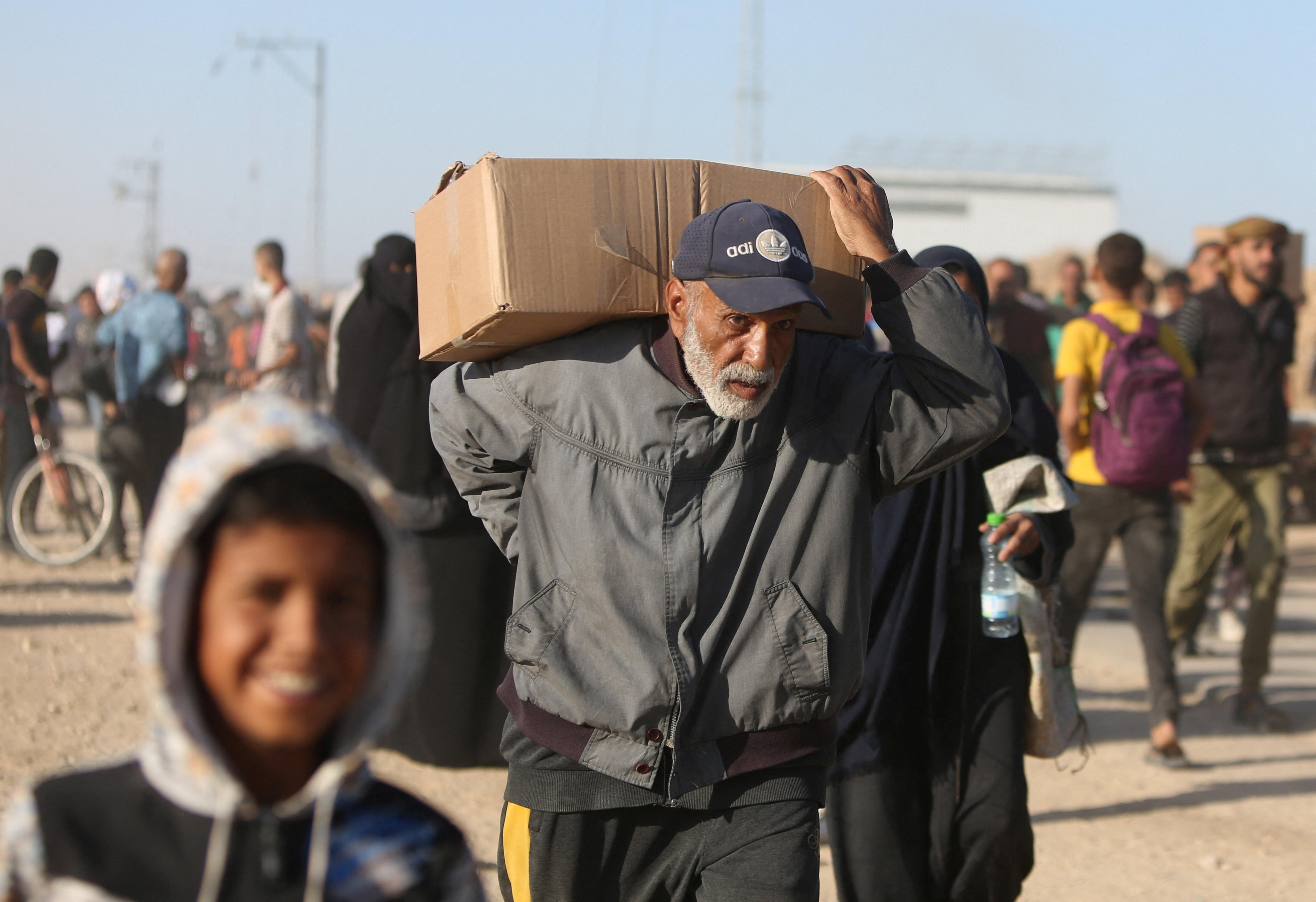 A Palestinian man carries aid supplies 