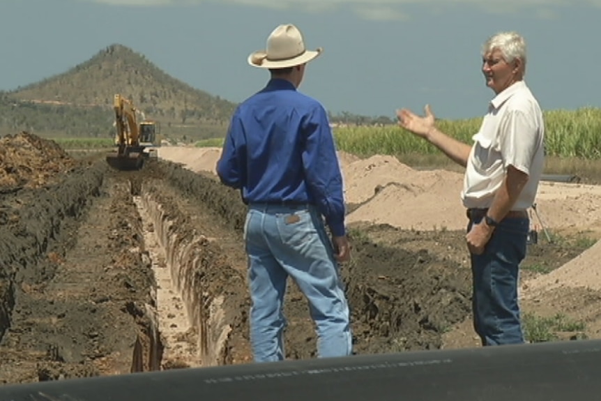 Geoff Cox stands in the midst of a paddock that was burnt