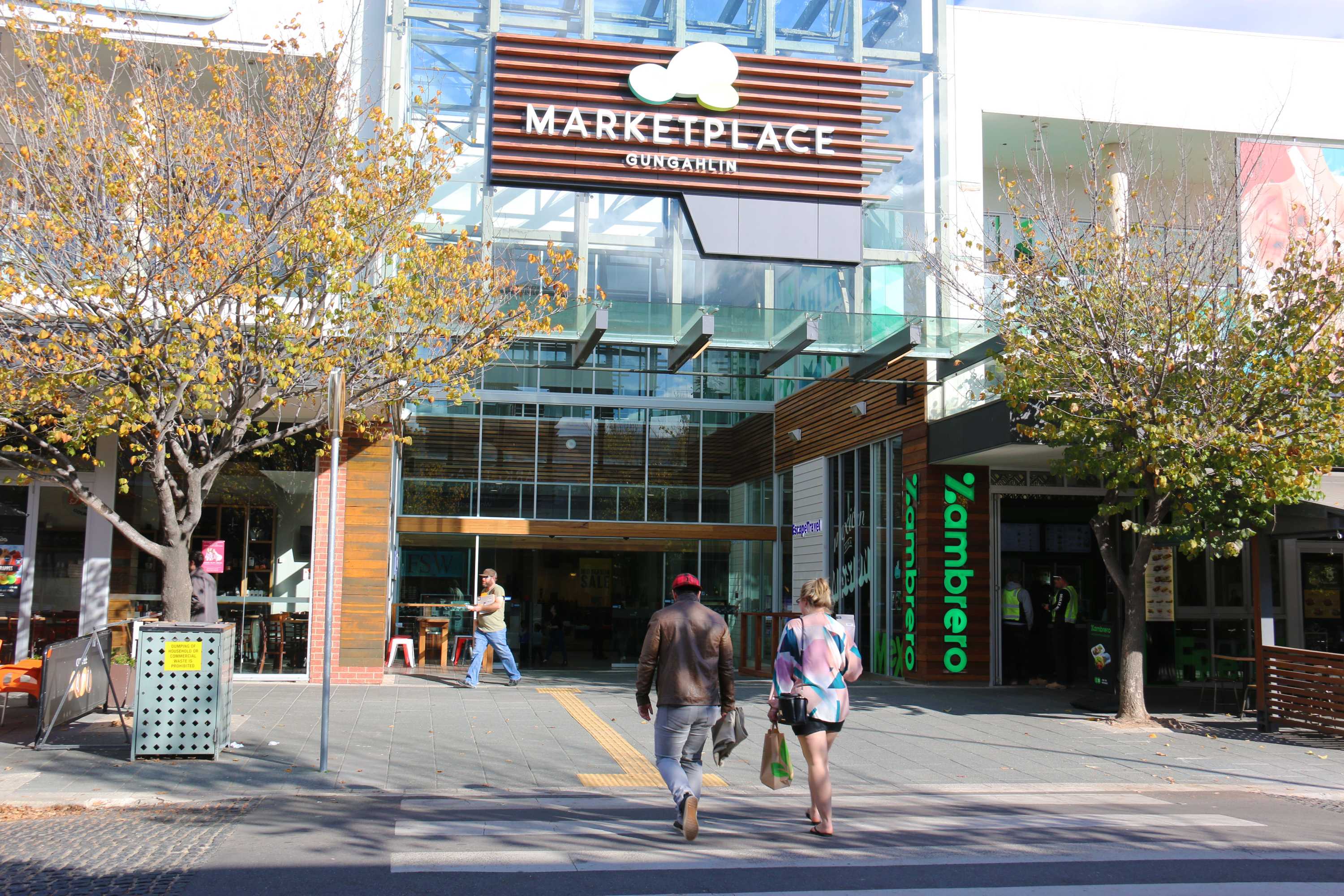 Shoppers entering Gungahlin Marketplace in Canberra.