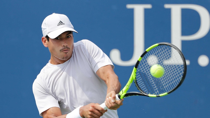 Jason Kubler returns a shot to Roberto Bautista Agut in the 2018 US Open first round.
