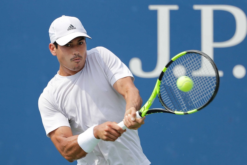 Jason Kubler returns a shot to Roberto Bautista Agut in the 2018 US Open first round.