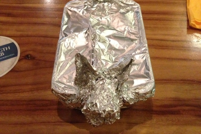 An alfoil-covered doggy bag in a dog shape
