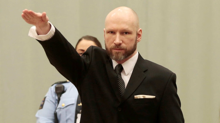 Anders Behring Breivik raises his right hand during the appeal case.