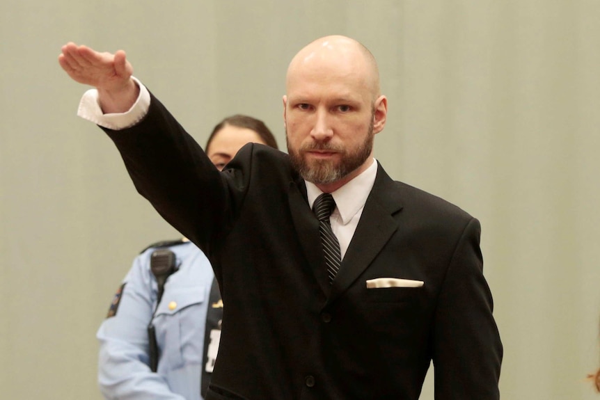 Anders Behring Breivik raises his right hand during the appeal case.