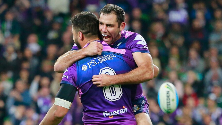 Jesse Bromwich of the Storm is congratulated by Cameron Smith after he scored a try