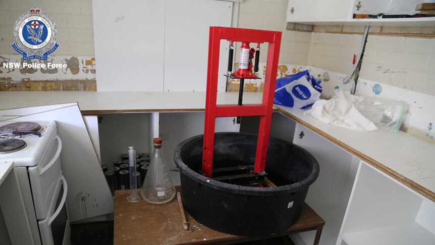 A large plastic bucket with chemistry equipment.