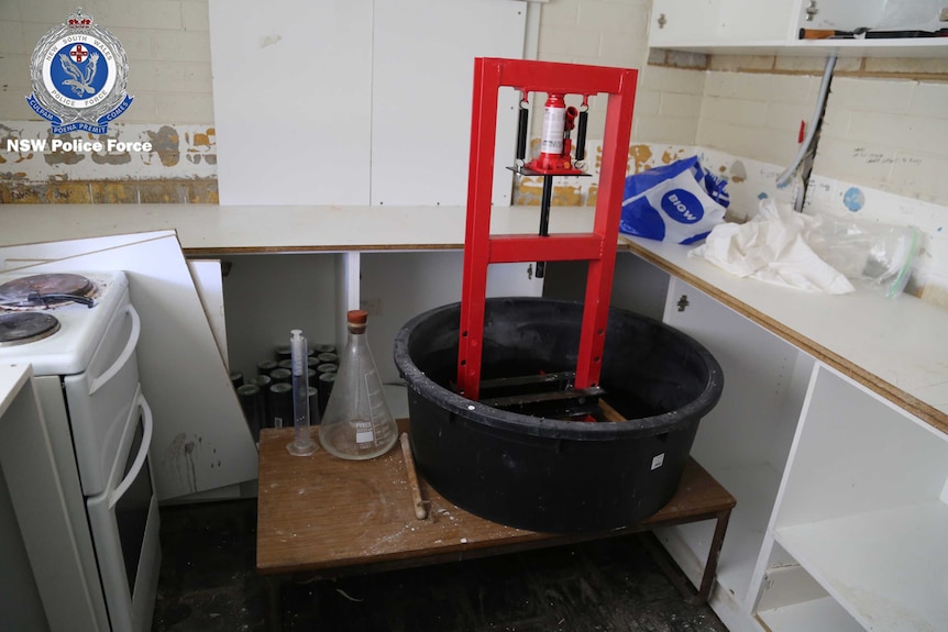 A large plastic bucket with chemistry equipment.