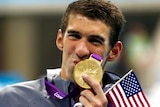 Michael Phelps of the US kisses his 19th Olympic medal, won in the men's 4x200m freestyle relay.