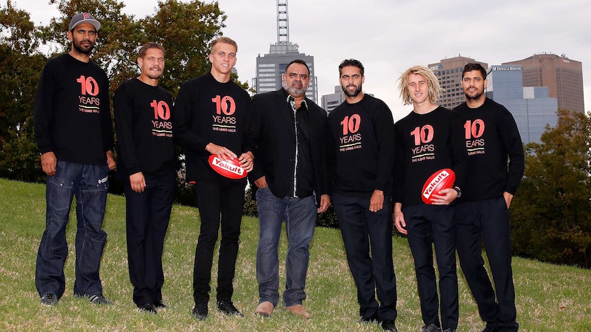 Michael Long and Essendon players celebrate the 10th anniversary of 'The Long Walk'