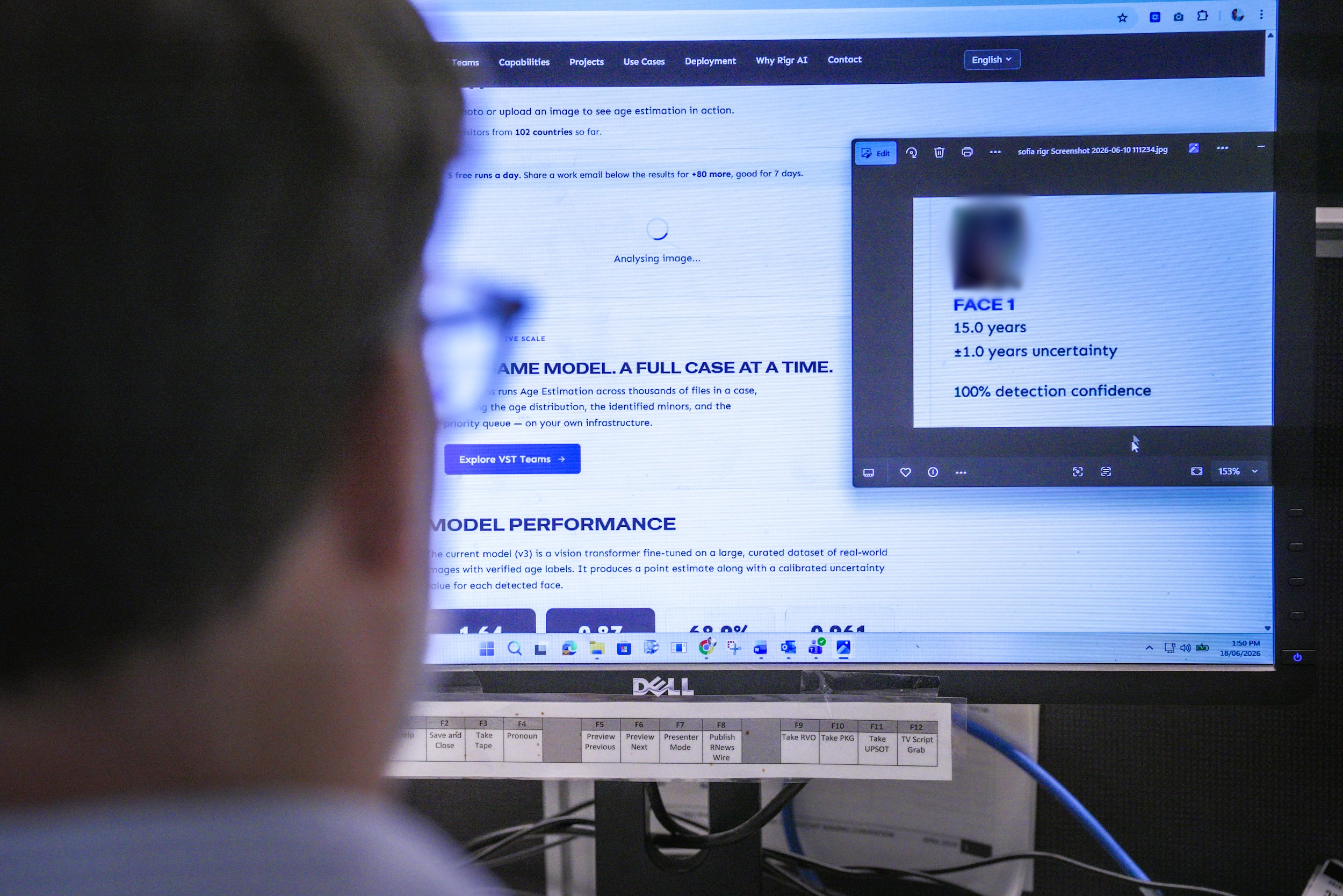 A journalist looks at a computer screen with an umage of a character on it and an age estimation that says 15 years.