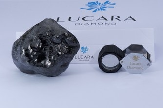 The large diamond is on the right, with the company's logo in the background