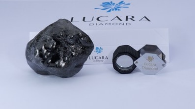 The large diamond is on the right, with the company's logo in the background