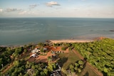 An aerial image of a small beachside holiday village