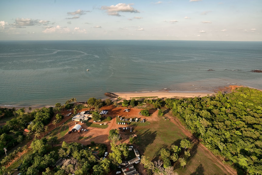 An aerial image of a small beachside holiday village