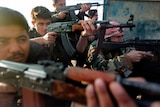 Soldiers of the Free Syrian Army, formed by army deserters, take position in an undisclosed location in Syria