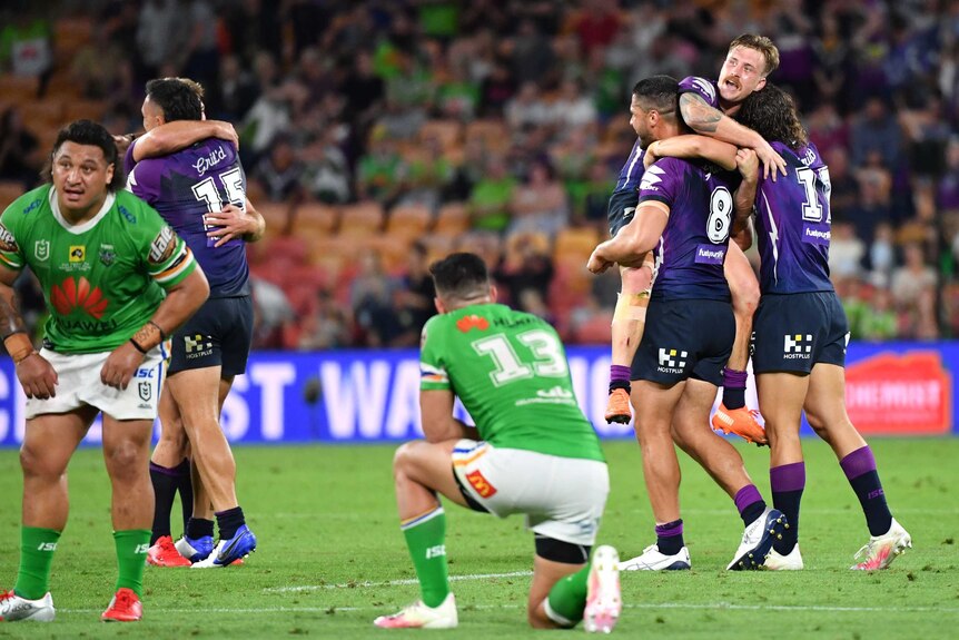 Storm players celebrate while Raiders players look down-trodden.