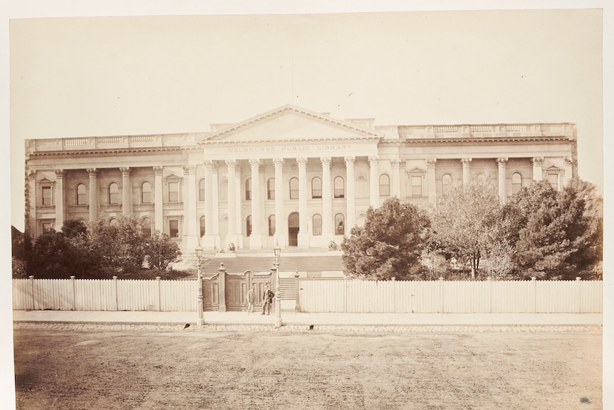 A large public building with columns at the covered entrance.