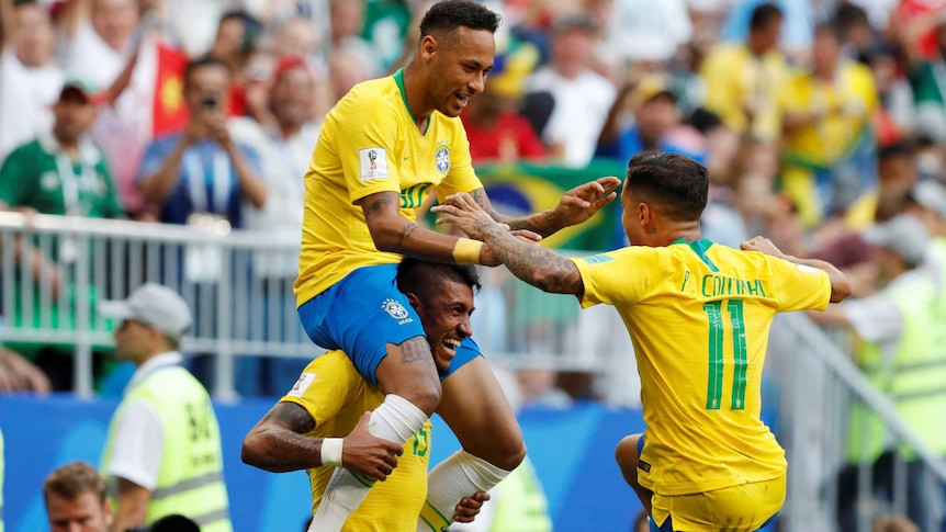 Neymar sits on Paulinho's shoulders after scoring