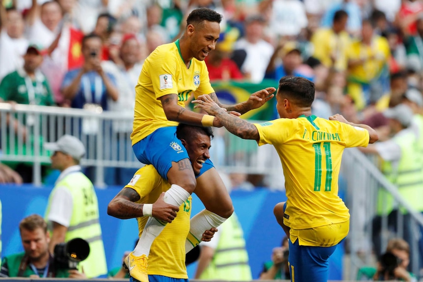 Neymar sits on Paulinho's shoulders after scoring