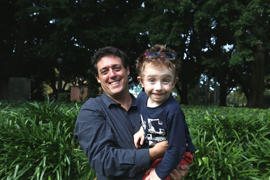 Associate Professor Stuart Khan with his son Herbie on his shoulders