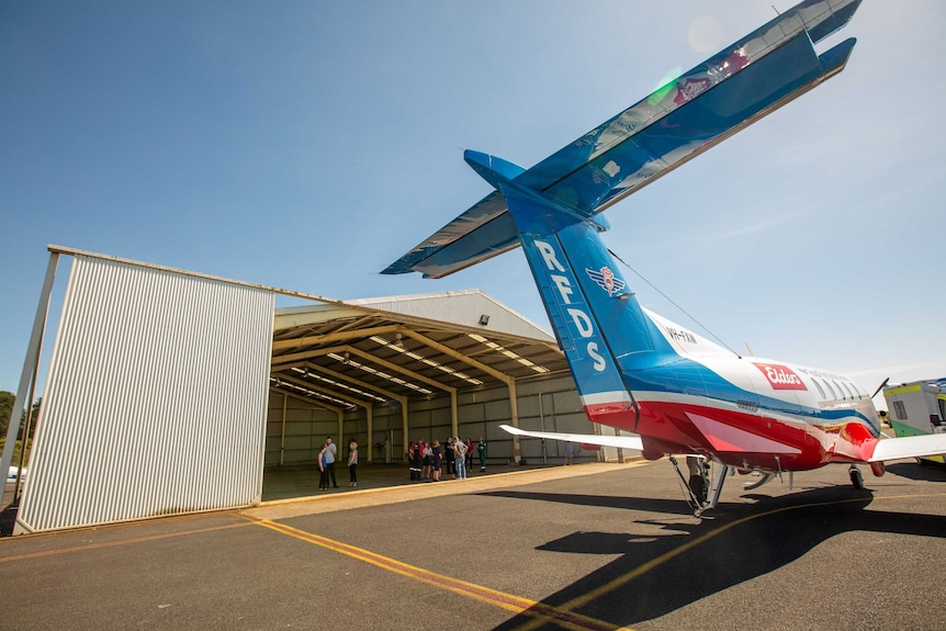 The tail end of an RFDS plane with the new plane hangar in the background