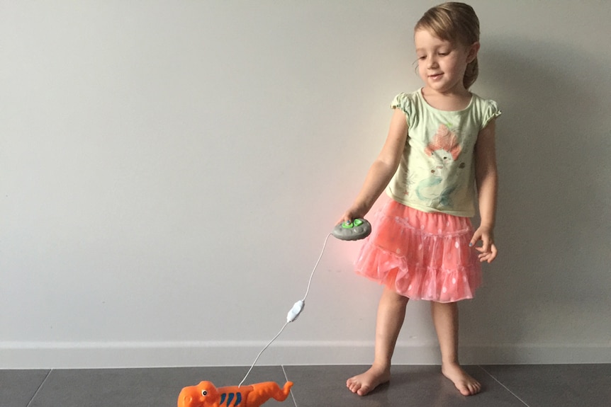 little girl playing with battery powered toy.