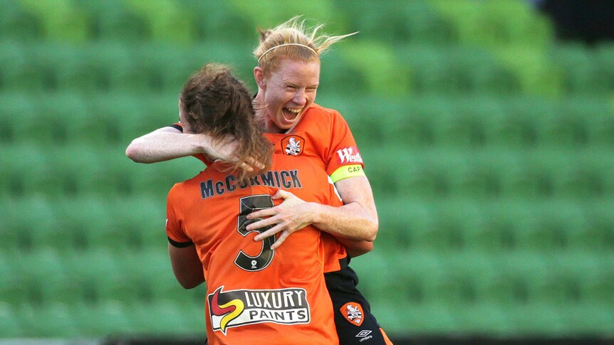 Clare Polkinghorne and Jenna McCormick jump into each others arms hugging each other