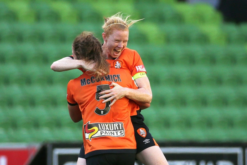 Clare Polkinghorne and Jenna McCormick jump into each others arms hugging each other