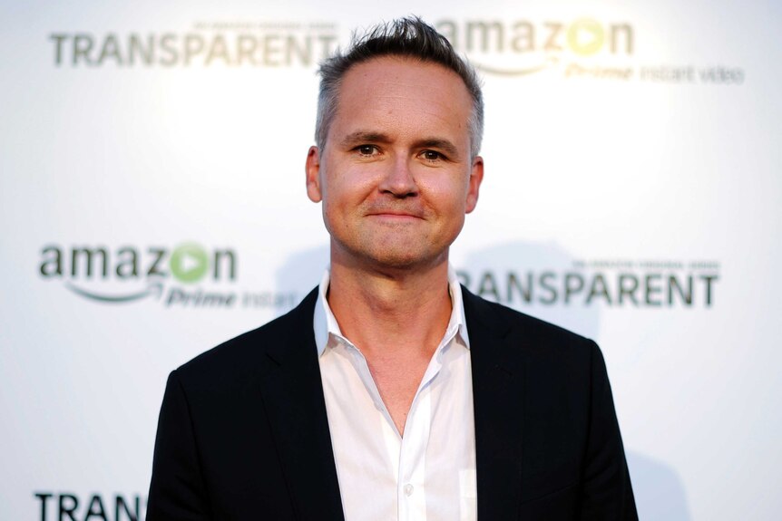 Roy Price, the director of Amazon Studios, poses on the red carpet.