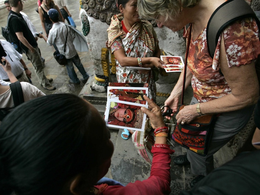 Tourists buy postcards of Preeti's face in Kathmandu
