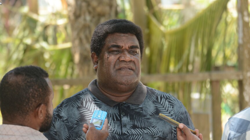 Godfrey Teamana, a recruiter in the Solomon Islands, being interviewed by journalists.