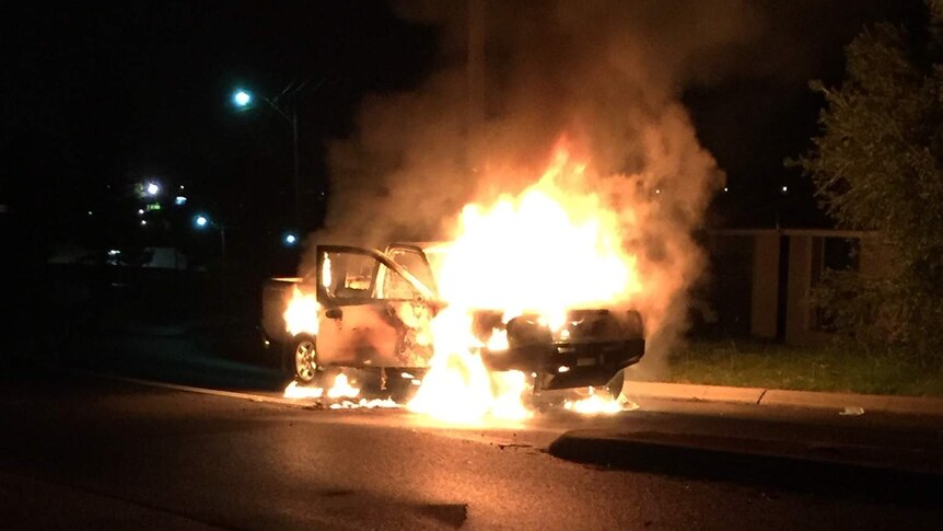 A car on fire on a suburban street suspected used in ram raid Greenwood shops.