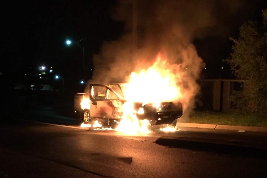 A car on fire on a suburban street suspected used in ram-raid Greenwood shops.