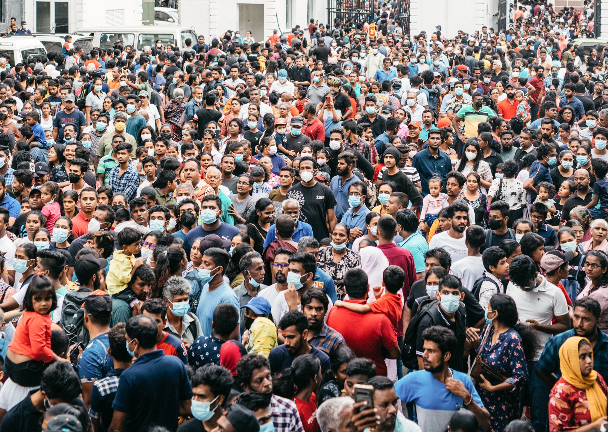 A crowd of people on a street outside the presidential palace in Sri Lanka.