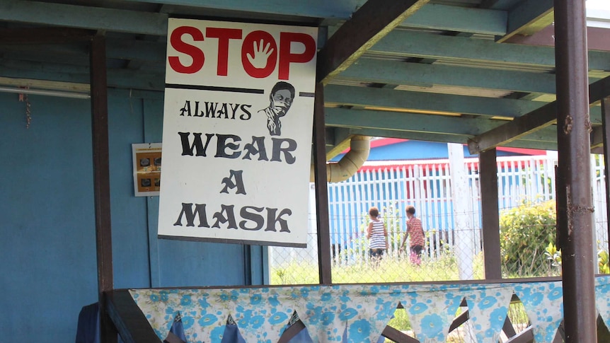 A sign at a health facility in Daru warns of the importance of wearing masks.