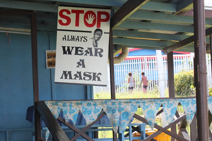 A sign at a health facility in Daru warns of the importance of wearing masks.