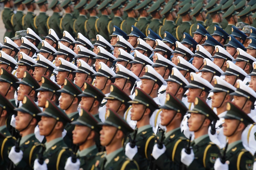 Soldiers of People's Liberation army standing in line holding riffles wearing white, blue and green uniforms