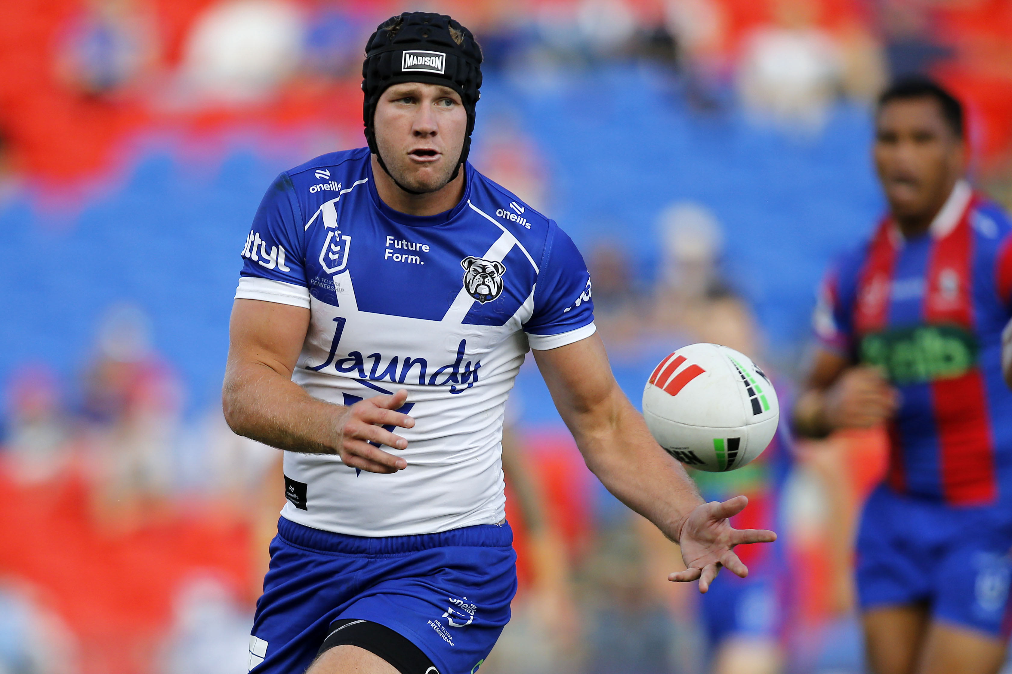 MAtt Burton passing the ball to his right during a rugby league match