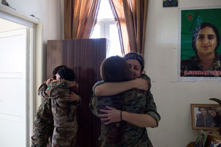 YPJ Kurdish members greet each other at a base in Ein Eissa city
