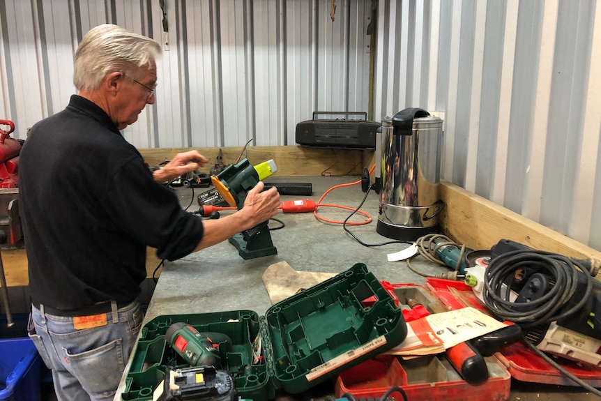 A man in a tool workshop.