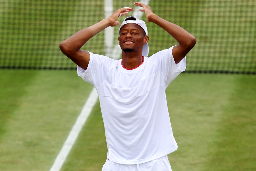 Chris Eubanks smiles after winning a match at Wimbledon.