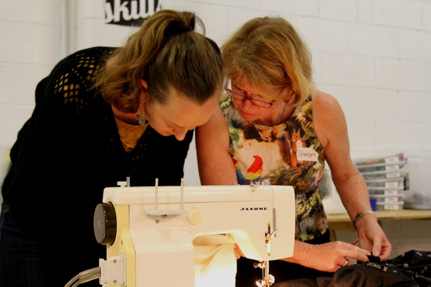 Helen Markland and Sharyn Doyle work on sewing.