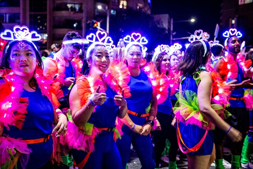 women wearing love hearts on their heads at the mardi gras parade