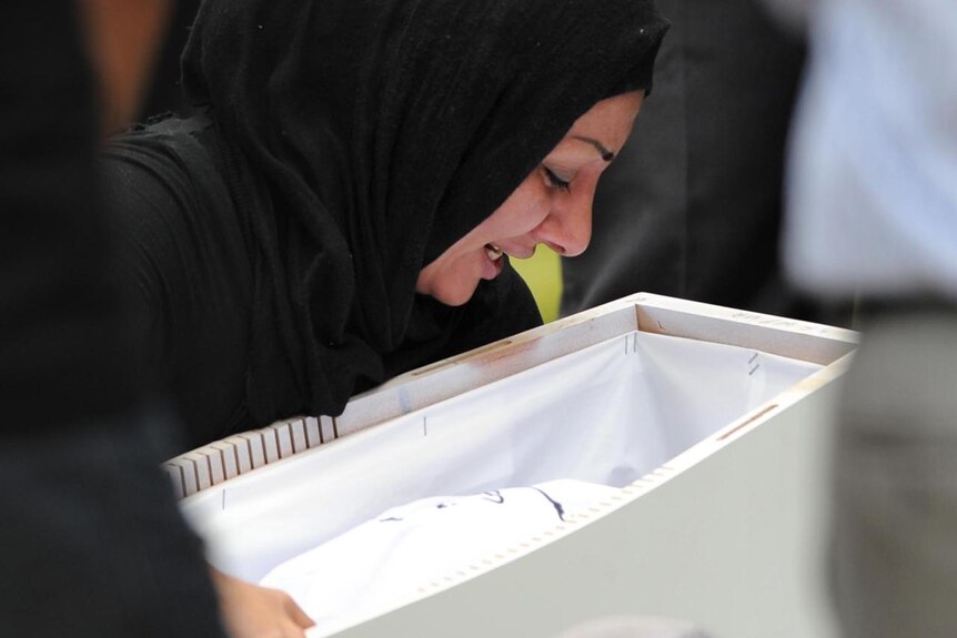 A mourner grieves at the funeral of one of the Christmas Island boat tragedy victims (AAP: Dean Lewins)
