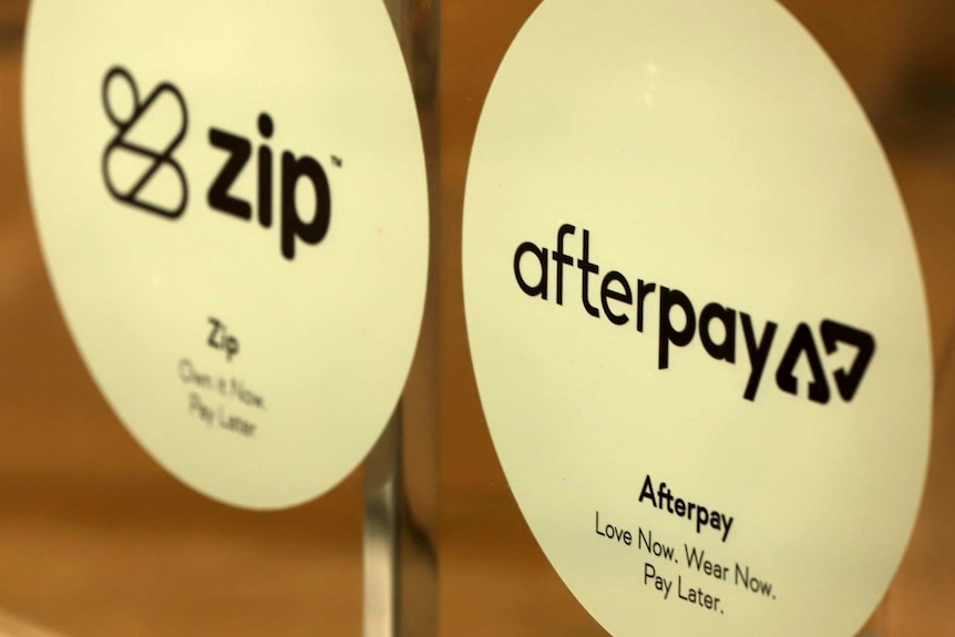 Zip and Afterpay signs on a shop door