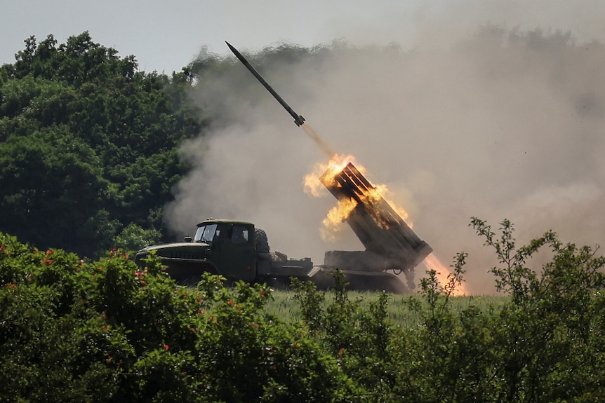 A rocket is launched from the raised back of a truck.