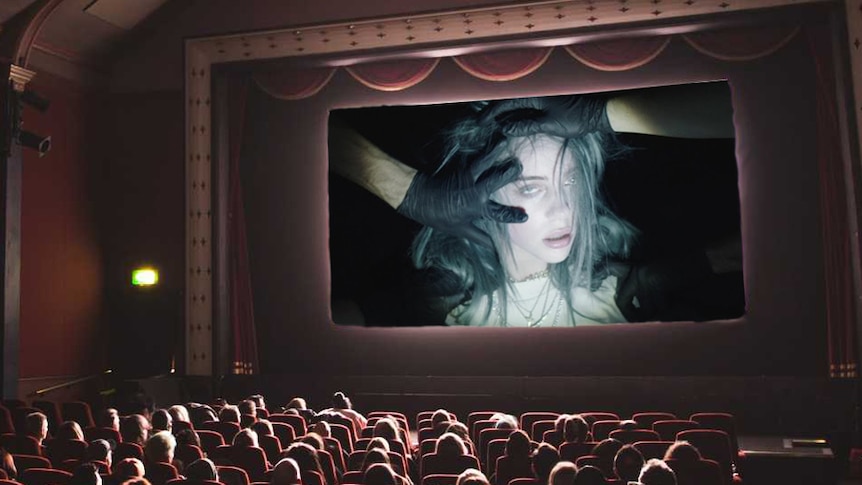 An image of a packed movie cinema watching Billie Eilish's music video for 2019 single 'bury a friend'